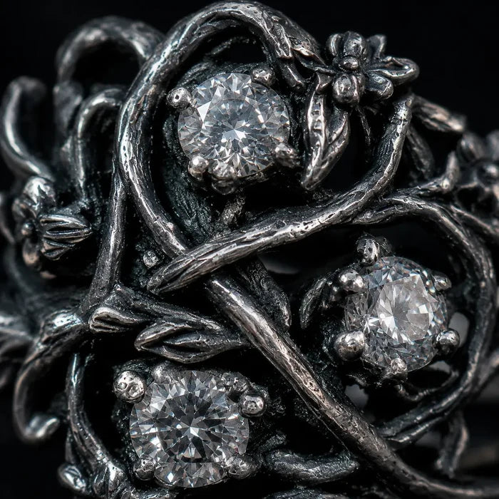 Blackthorn vine ring close-up — chiaroscuro branch patina, textured briars and thorn detail in 925 sterling silver