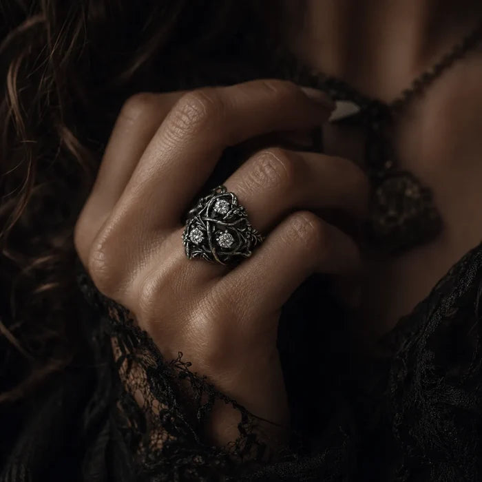 Hand wearing blackthorn vine three-stone ring with lab diamond — alternative engagement ring in 925 sterling silver