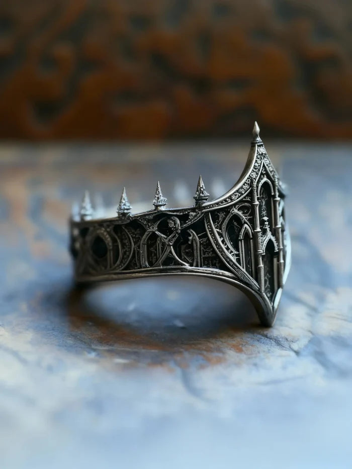 Medieval gothic crown ring close-up — openwork lancet windows and ribbed buttresses, deep oxidized recesses