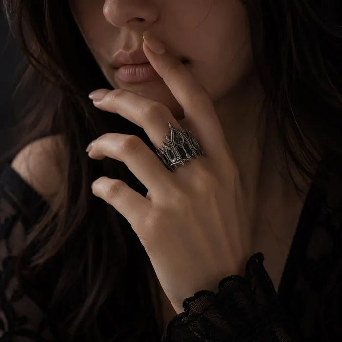 Woman wearing gothic cathedral crown ring — sterling silver statement ring in dark moody lifestyle shot