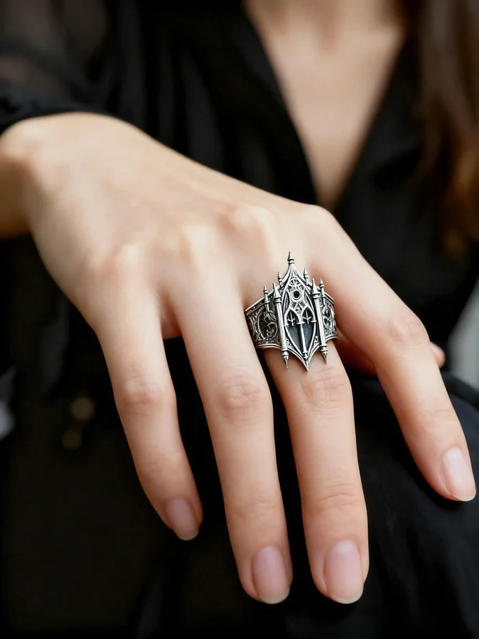 Hand wearing gothic cathedral facade ring — alternative wedding ring with tiara-like crown silhouette