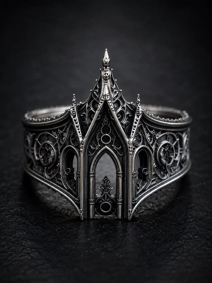 Gothic lancet arch ring close-up — layered openwork filigree and chiaroscuro oxidized patina