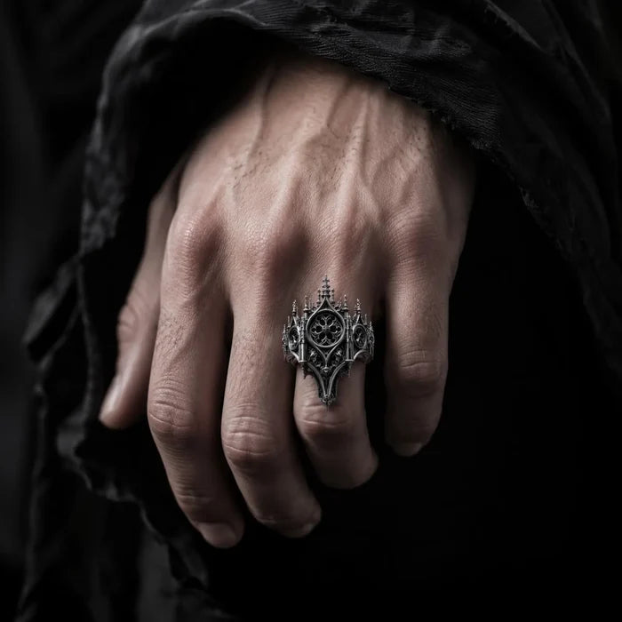 Hand wearing gothic cathedral rose window crown ring — alternative engagement ring with shadow crown silhouette