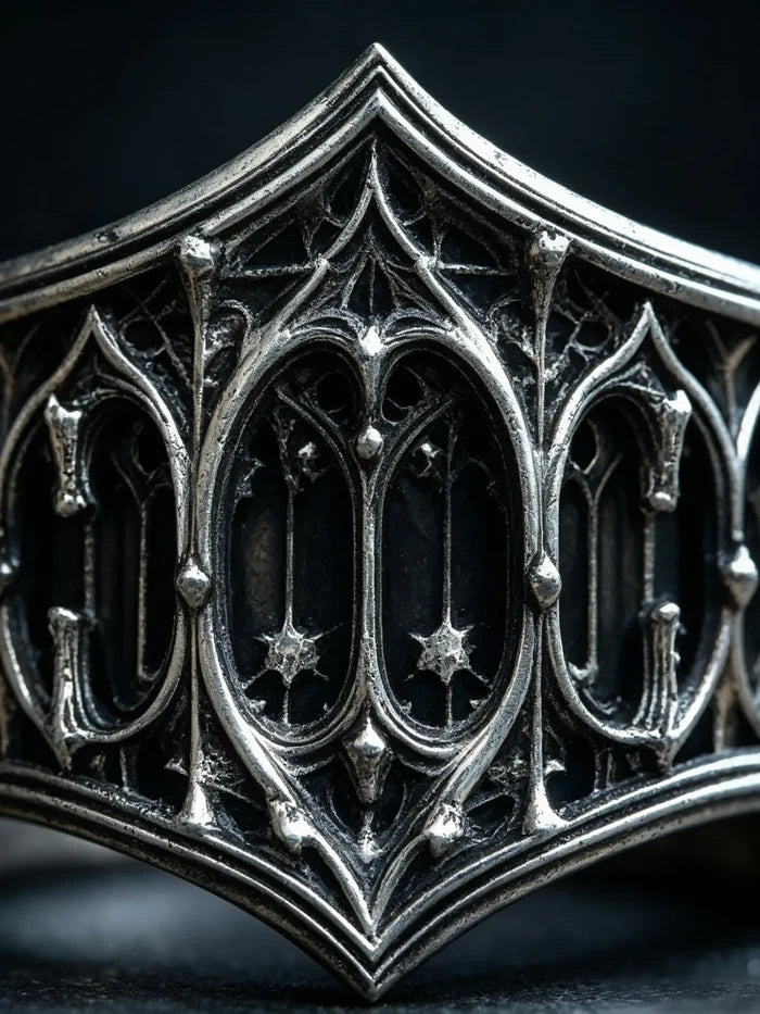 Macro detail of the carved Gothic lancet-window tracery and star motifs on the sterling silver band