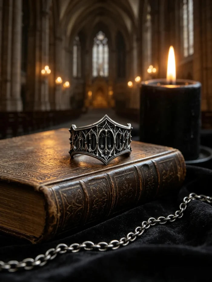 Cathedral Tracery Ring resting on an antique book with a cathedral interior behind