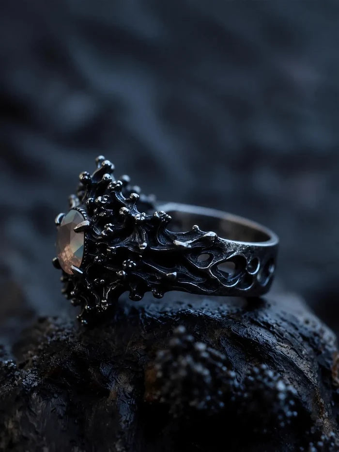 Side view of the Dark Bloom Ring showing the sculptural black oxidized band and raised blooms