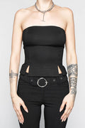 Person wearing a black strapless top and black pants with a belt on a plain background