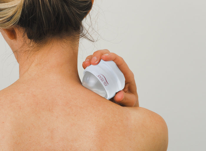 Elle TENS massage roller ball used on back for muscle tension relief