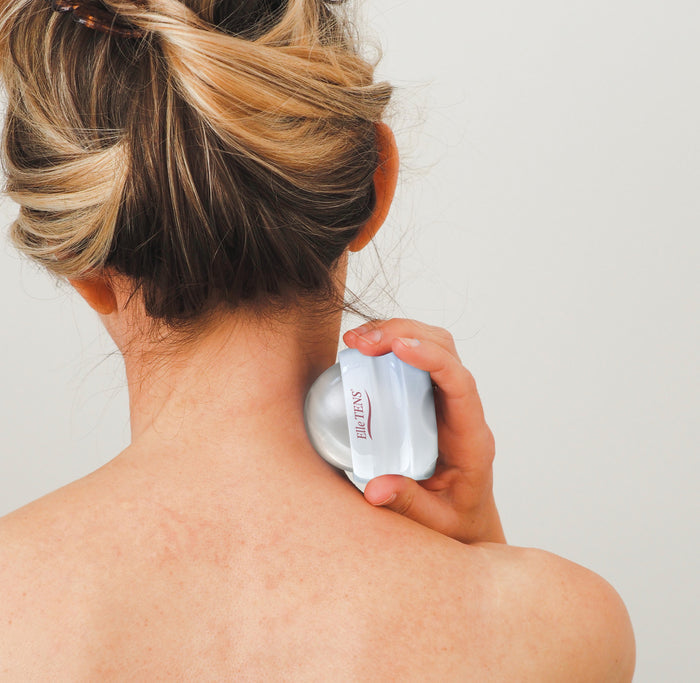 Elle TENS massage roller ball used on neck for relaxation and pain relief