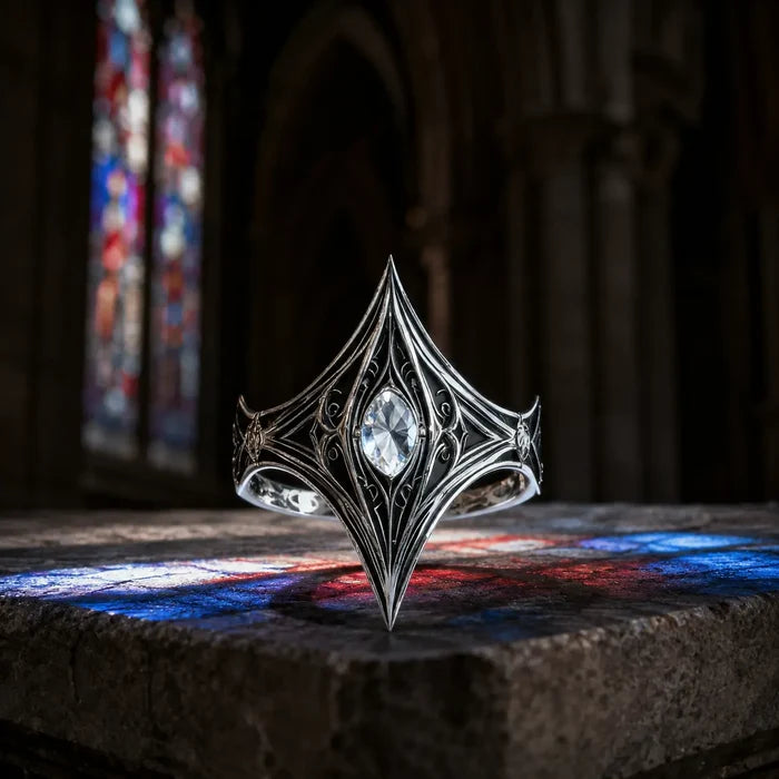 Elven Tear Ring in oxidized sterling silver with marquise moissanite, front view on a stone ledge with cathedral stained glass