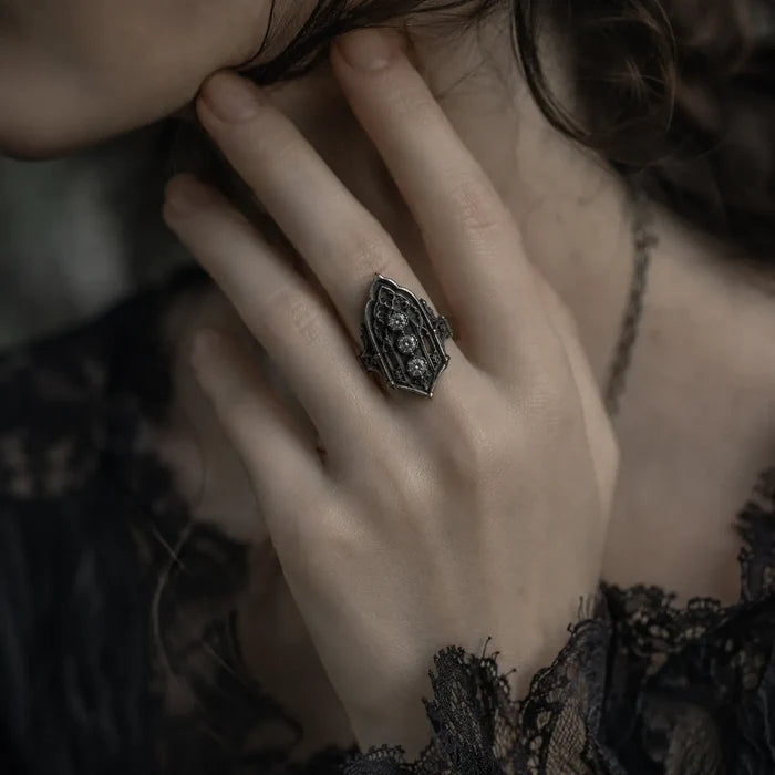 Close-up of a hand wearing an ornate ring with intricate design. moissanite, Victorian, oxidized silver