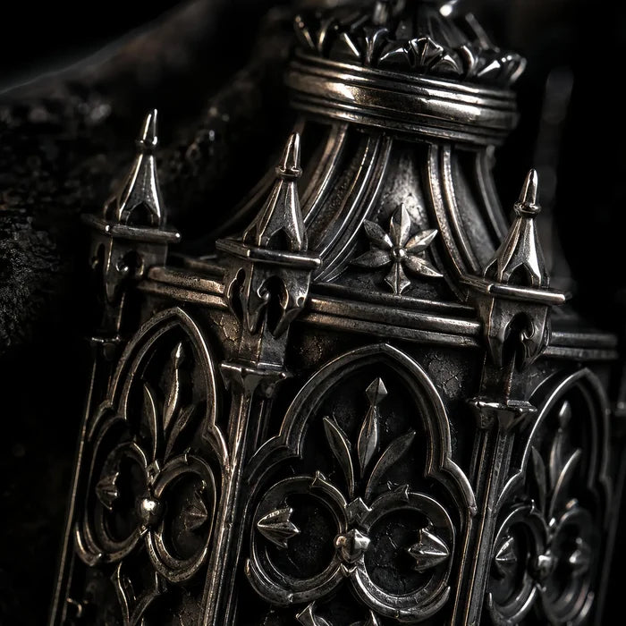 Macro detail of the Cathedral Lantern pendant's Gothic tracery, spires and fleur-de-lis in oxidized sterling silver