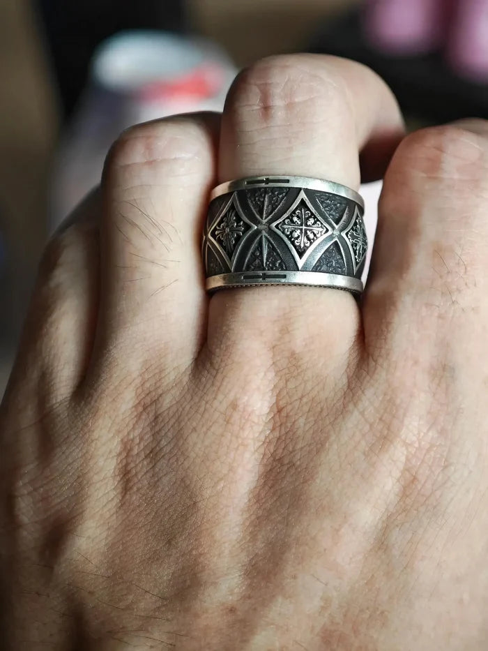 Hand wearing gothic cross wide band ring — alternative wedding band in solid 925 sterling silver