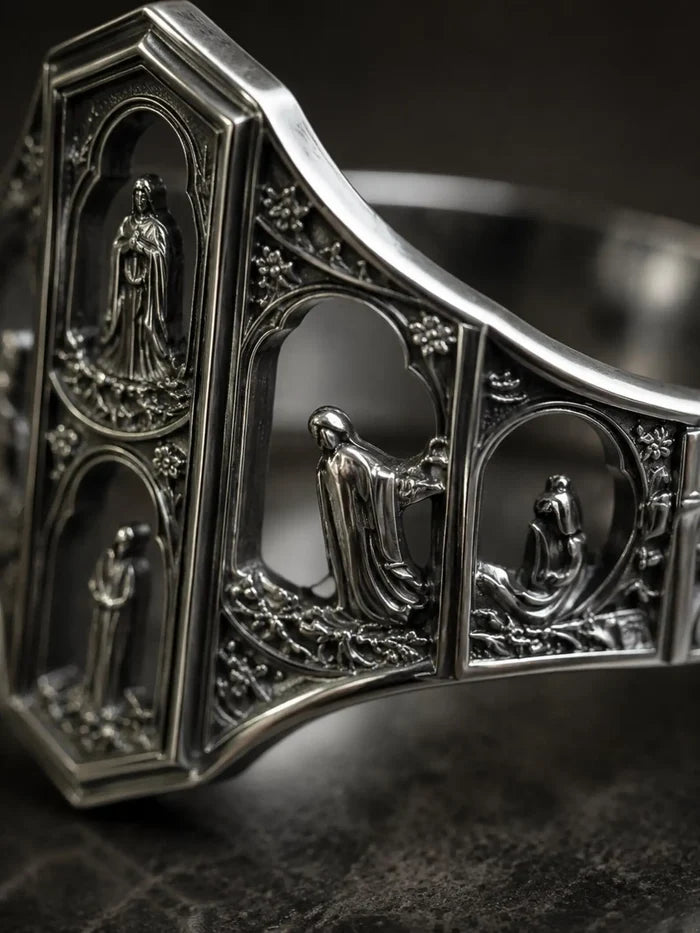 Macro detail of the Saints Prayer ring's miniature cathedral facade and saint reliefs in oxidized silver