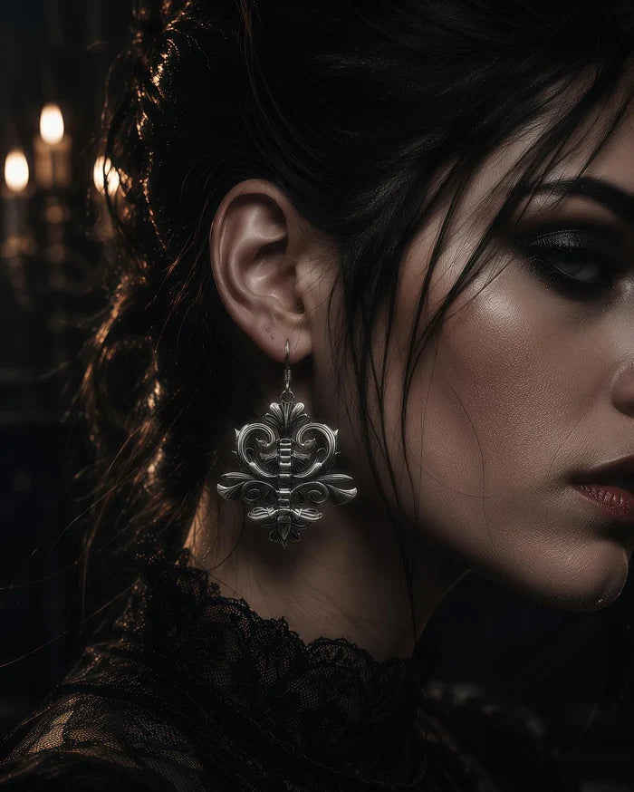 Spine motif dangle earring worn in ear, close-up