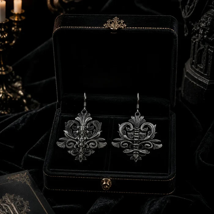Iris and Spine earrings displayed together in gothic-style jewelry box