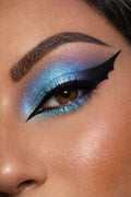 Close-up of a person's eye with blue and purple makeup