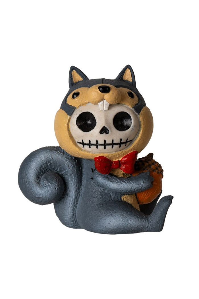 Squirrel figurine with skull head and bow tie holding an acorn on a white background