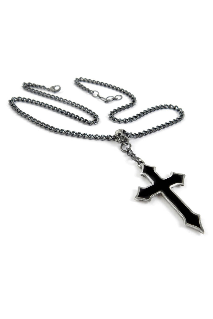 Black cross pendant on a chain against a white background