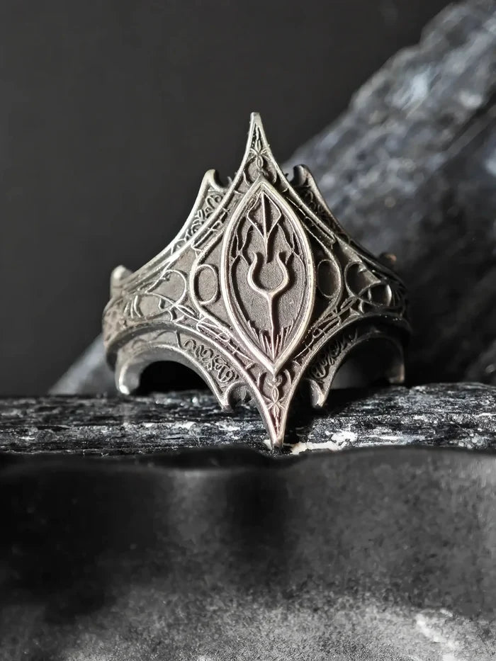 Front view of the Relic Prophecy Ring's engraved rune cartouche and thorned filigree in oxidized silver