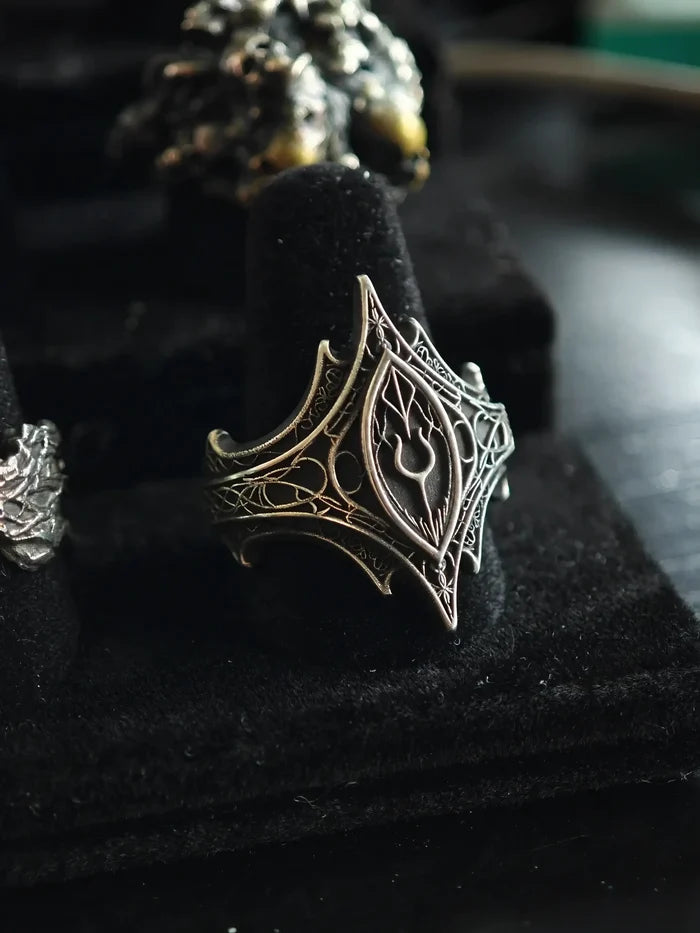 Angled view of the Relic Prophecy Ring on a display stand, hand-carved oxidized 925 sterling silver