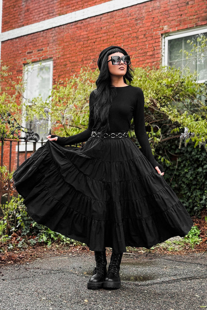 gothic woman wearing a tiered long skirt