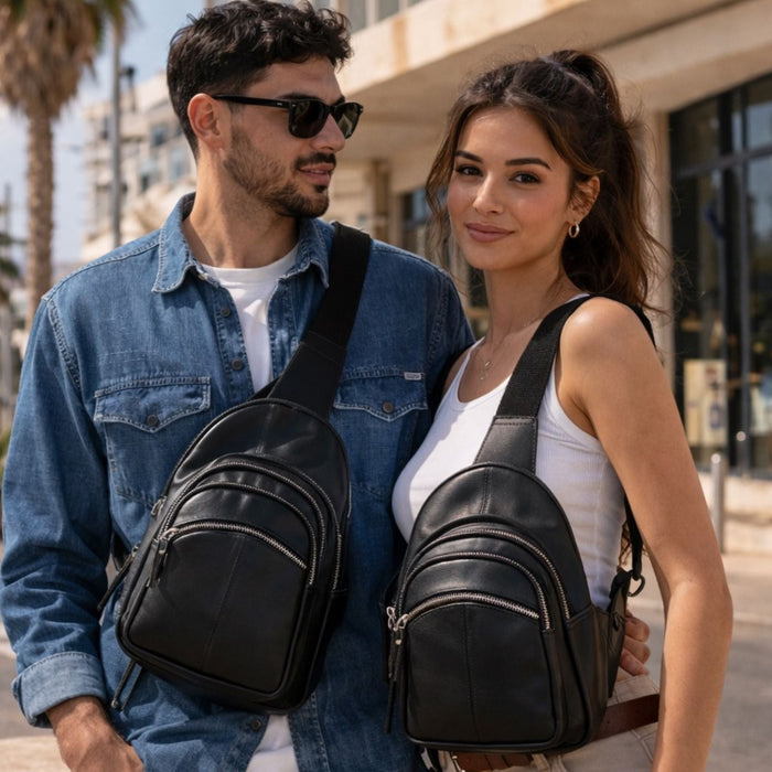 Man and woman standing together wearing black leather backpacks on a city street. aled Carry Harley Lambskin Sling by DS Conceal - Tactical Sling Gun Bag - Unisex Universal Holster Bag - Firearm CCW Gear - Backpack for Concealed Carry - Pistol Bag