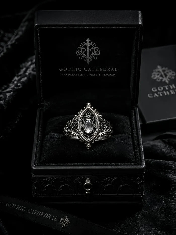 Sanctuary Window Ring detail, faceted stone catching light in silver tracery frame