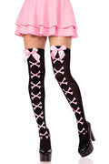 Black knee-high socks with pink bows and cross patterns worn with a pink skirt and black shoes on a white background.