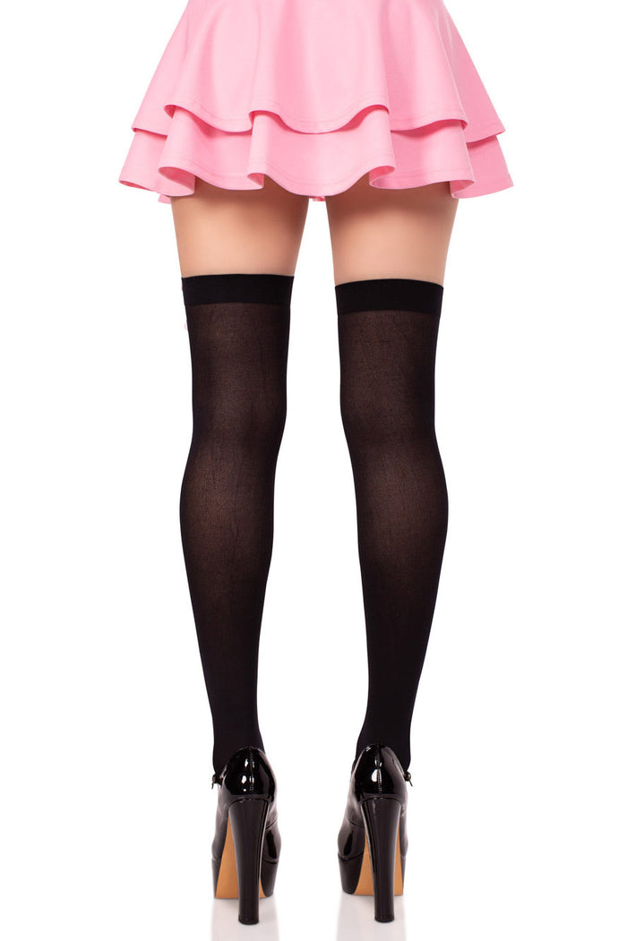 Black thigh-high stockings worn with a pink skirt and high heels on a white background