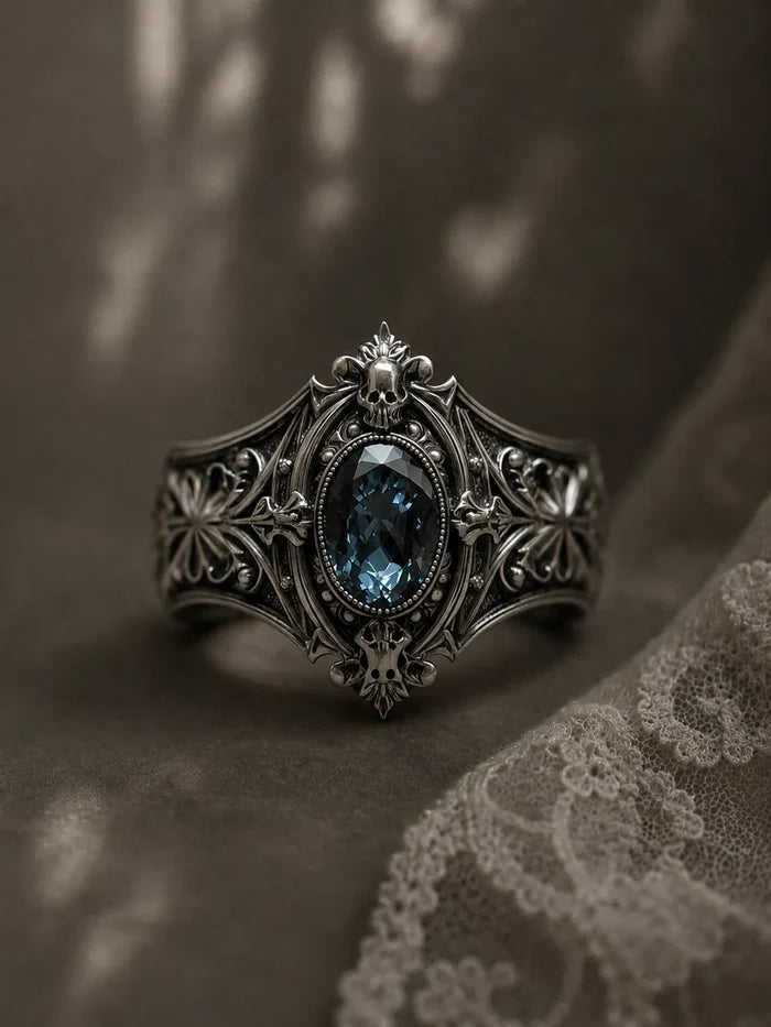 Victorian 925 sterling silver memento mori skull ring with London blue topaz — micro skull reliefs front view